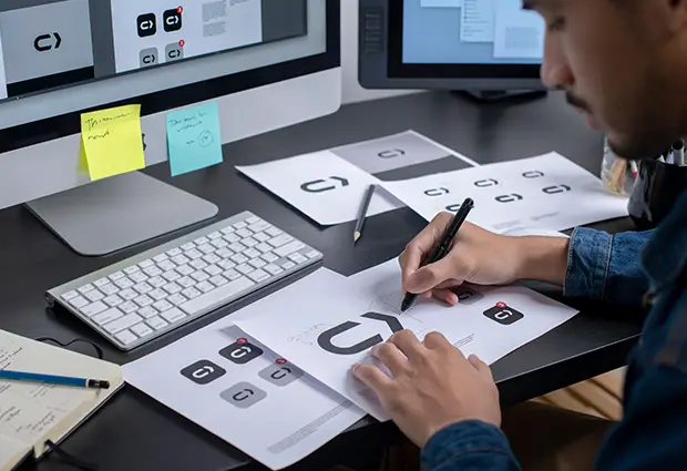 Graphic designer and illustrator in Austin working on custom logo concepts and sketches for local business branding.